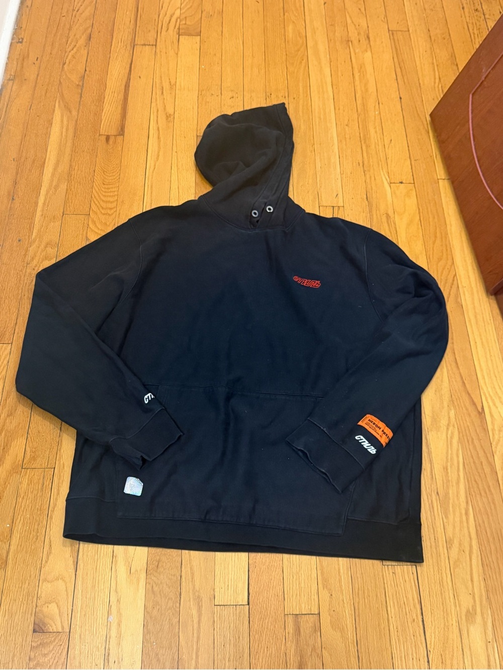 Heron Preston Black Hoodie with Orange Patch and White Cyrillic Embroidery